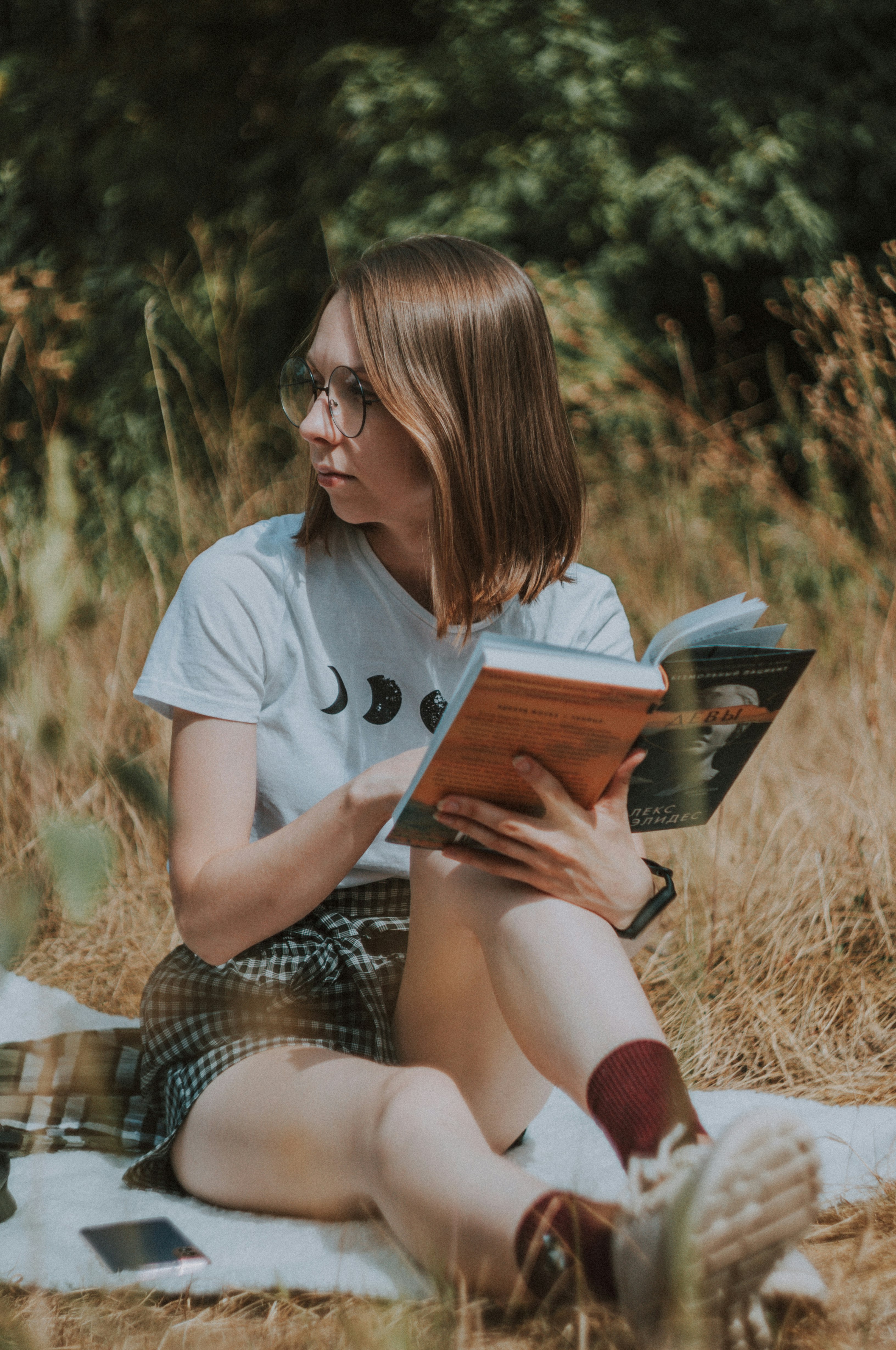 woman in white t-shirt reading book